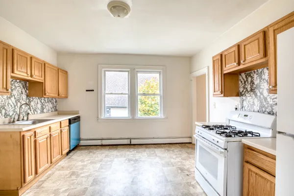 a kitchen with stainless steel appliances granite countertop a stove and a sink