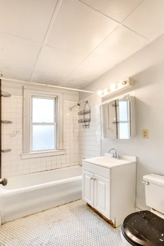a bathroom with a sink a toilet and bathtub