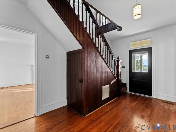 a view of an entryway with wooden floor