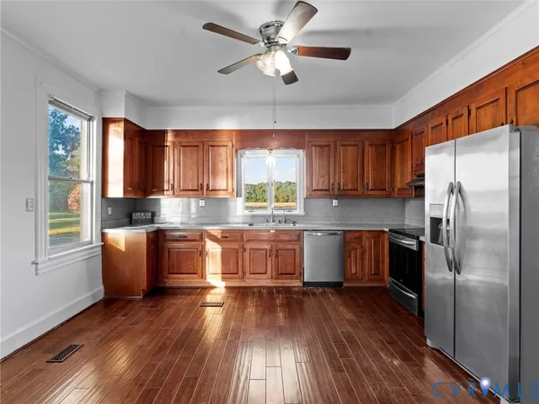 a kitchen with stainless steel appliances a sink and a window