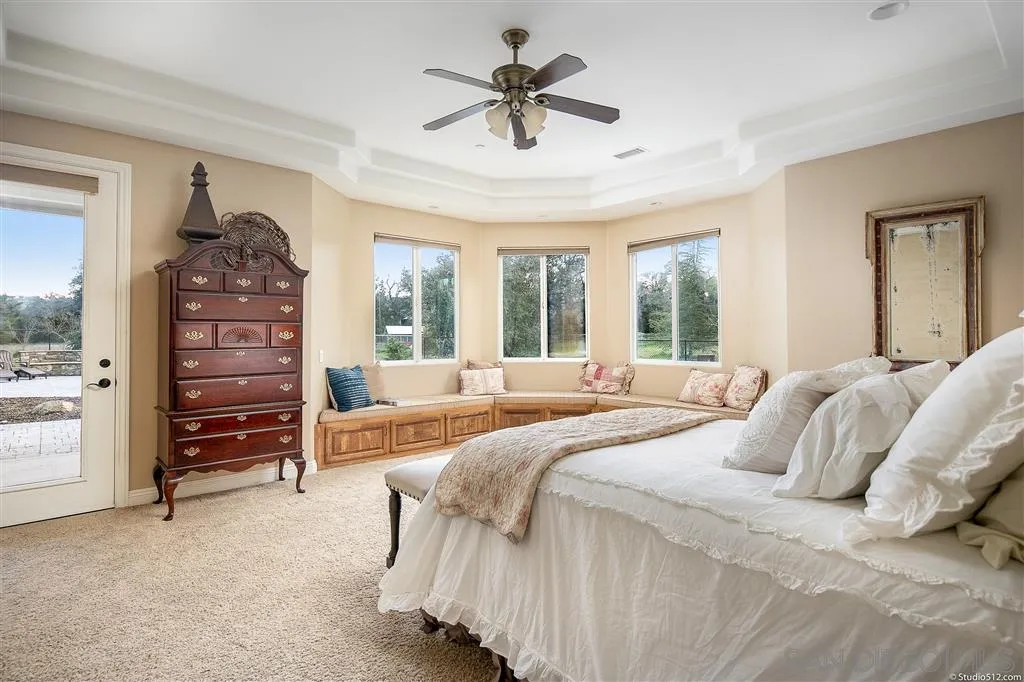 4047 Ritchie Road Santa Ysabel, CA 92070 - Photo 14 of 25 a bedroom with a bed and a chandelier