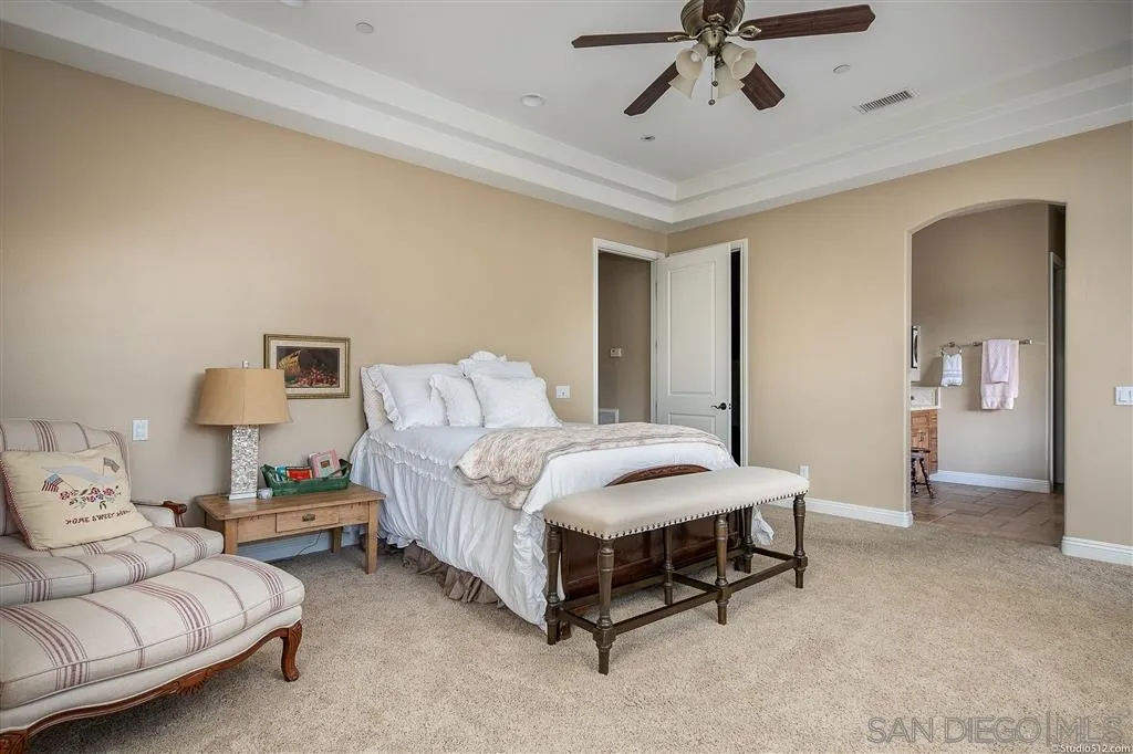 4047 Ritchie Road Santa Ysabel, CA 92070 - Photo 15 of 25 a bedroom with a bed and ceiling fan