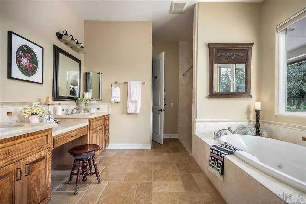 4047 Ritchie Road Santa Ysabel, CA 92070 - Photo 16 of 25 a bathroom with a tub a sink and a mirror