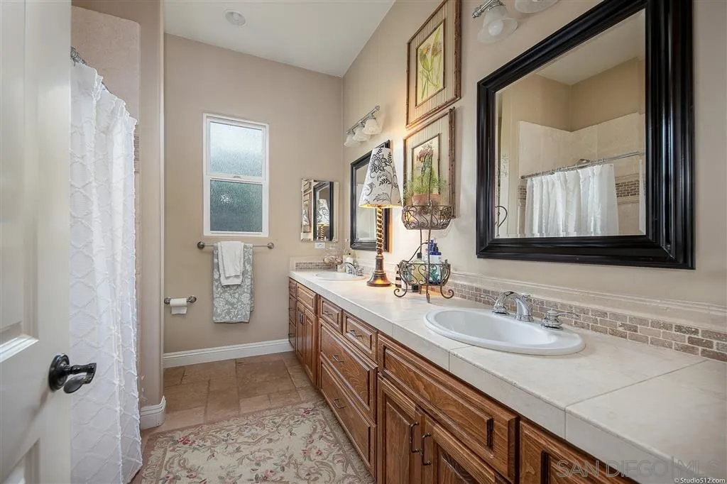4047 Ritchie Road Santa Ysabel, CA 92070 - Photo 19 of 25 a en suite bathroom with a granite countertop sink and a mirror