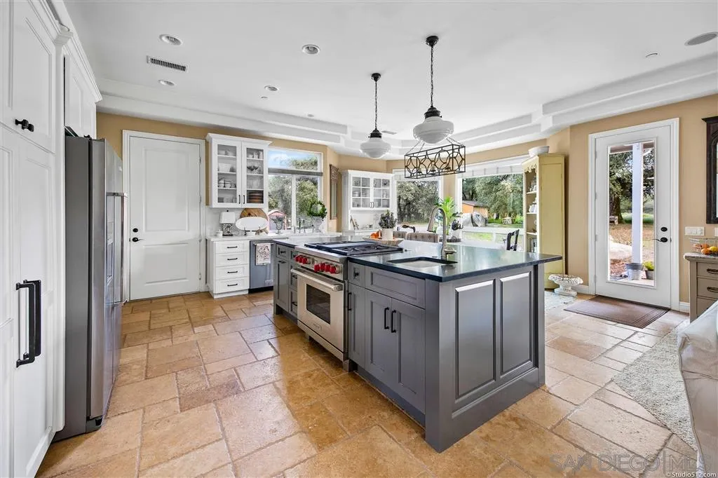 4047 Ritchie Road Santa Ysabel, CA 92070 - Photo 7 of 25 a kitchen with stainless steel appliances granite countertop a stove and a refrigerator