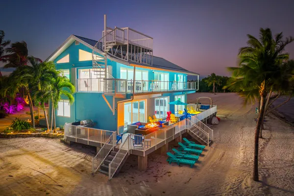 a view of a dining room with furniture wooden floor and chandelier