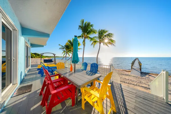 a bedroom with furniture and large windows