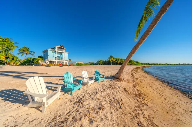 a spacious bedroom with a bed a couch and a large window