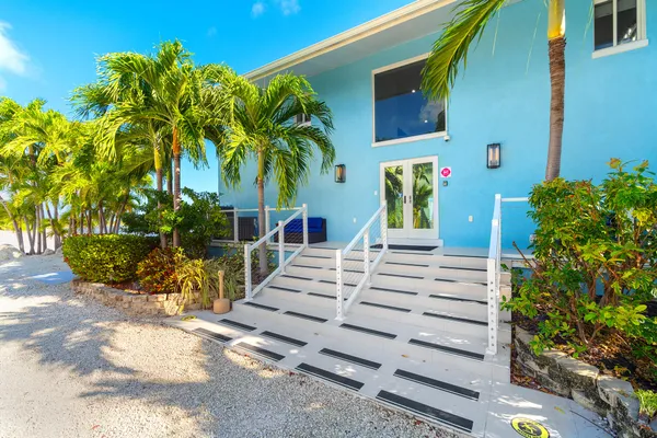 a bedroom with a white bed and a chandelier