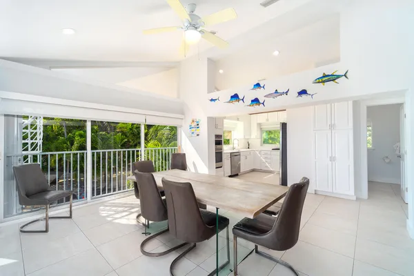 a view of a dining room with furniture a chandelier and wooden floor