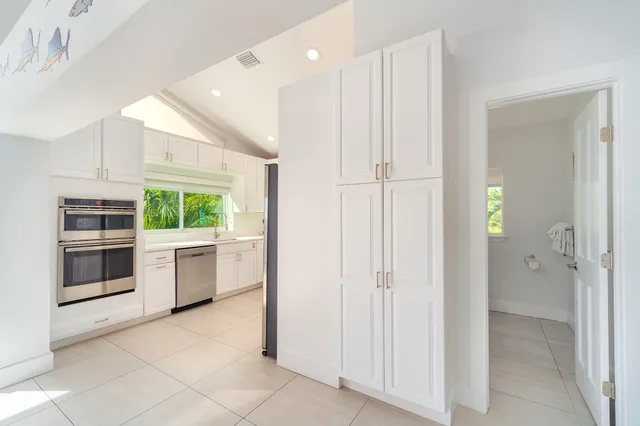 a view of a dining room with furniture and a chandelier