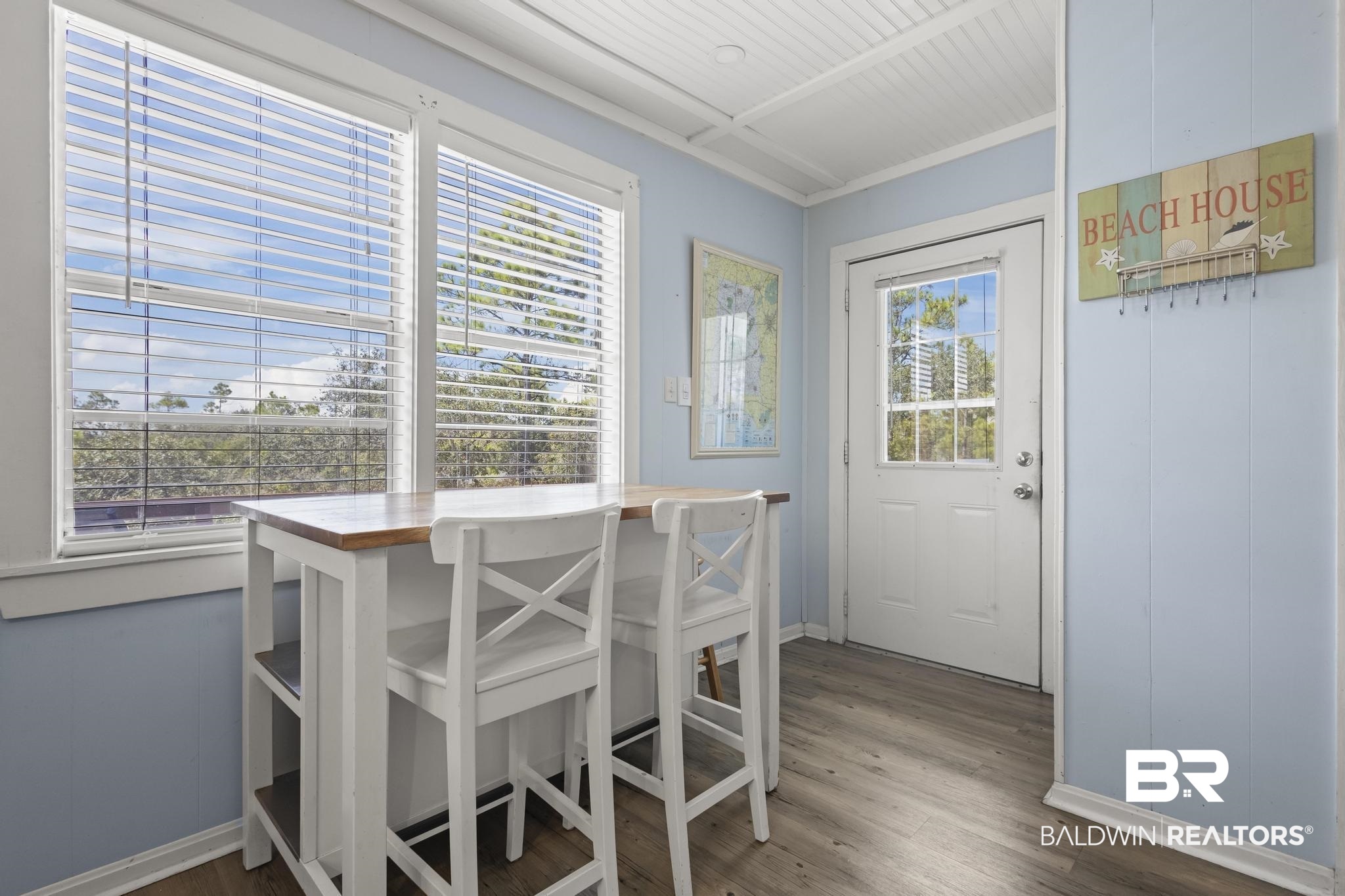 562 Veterans Road Gulf Shores, AL 36542 - Photo 9 of 32 Dining room featuring baseboards and wood finished floors