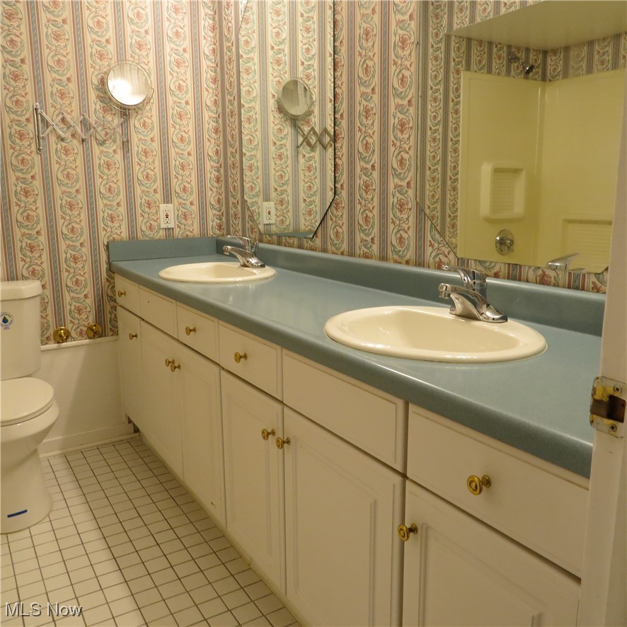 430 High Meadow Road Amherst, OH 44001 - Photo 17 of 29 Full bathroom with tile patterned floors, bathing tub / shower combination, vanity, and toilet