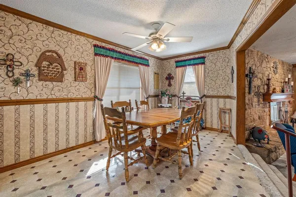 a view of a dining room with furniture and chandelier