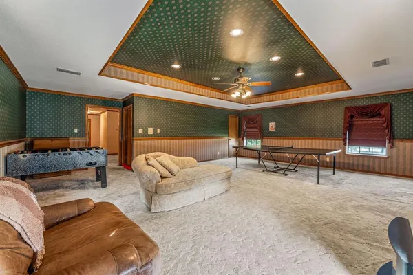 a living room with furniture and a potted plant