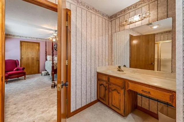 a bathroom with a double vanity sink a mirror and a bathtub