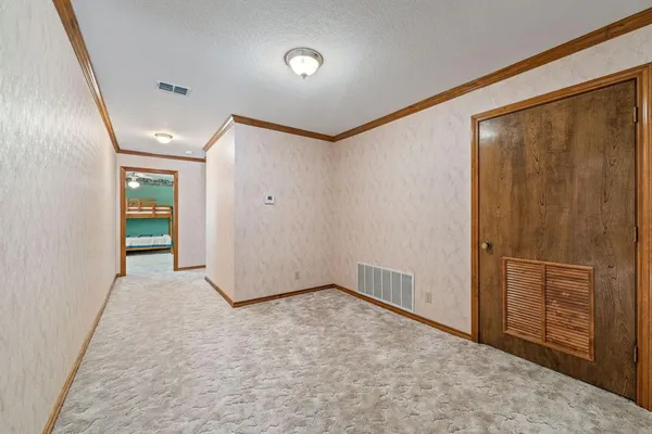 an empty room with closet and wooden floor