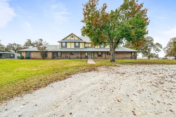 a view of a house with swimming pool next to a yard