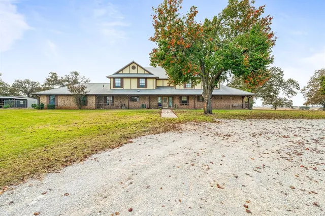 a view of a house with swimming pool next to a yard