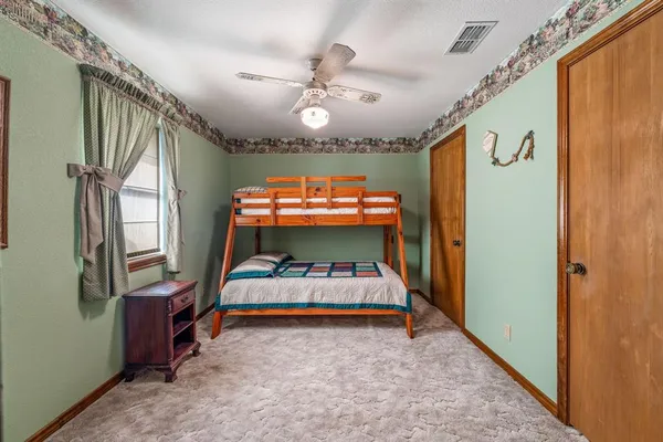 a bedroom with bed and window