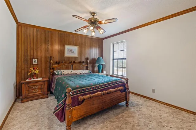 a room with a bed and a chandelier