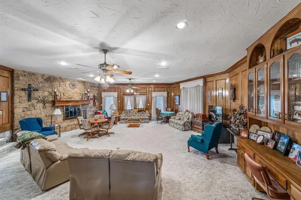 a living room with fireplace furniture and a chandelier