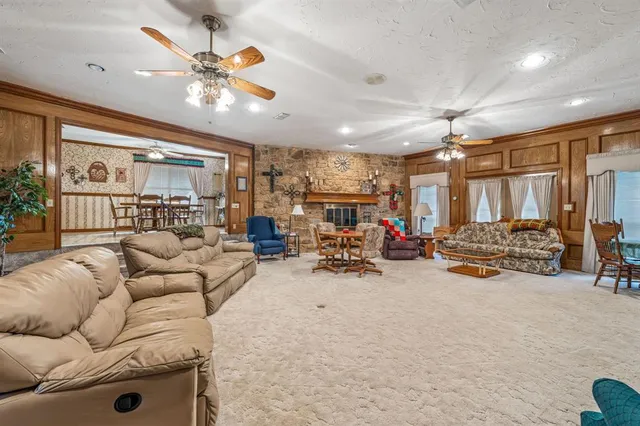 a view of a livingroom with furniture and a ceiling fan
