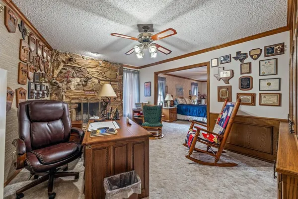a living room with furniture a flat screen tv and a floor to ceiling window