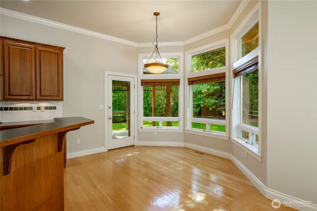 a house view with a sink outdoor dining space and a window