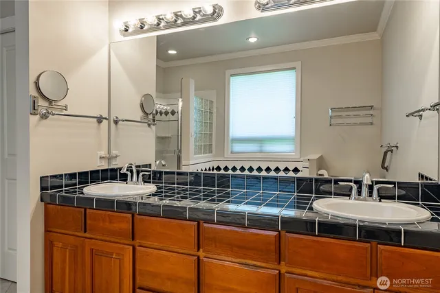 a bathroom with a double vanity sink and a mirror