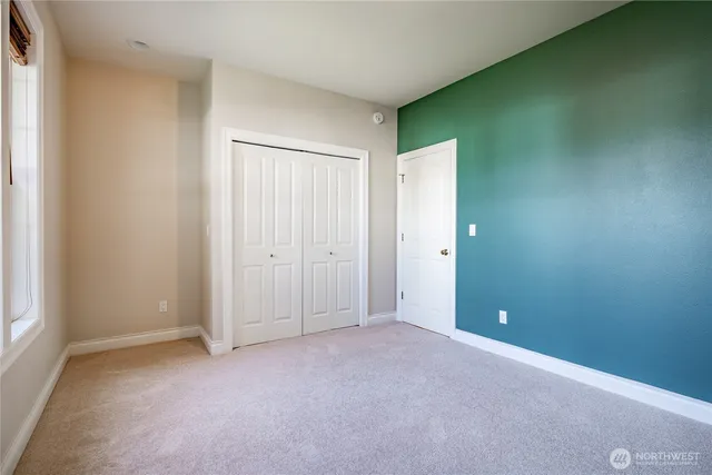 an empty room with closet area