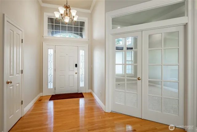 a view of a bedroom with wooden floor and windows