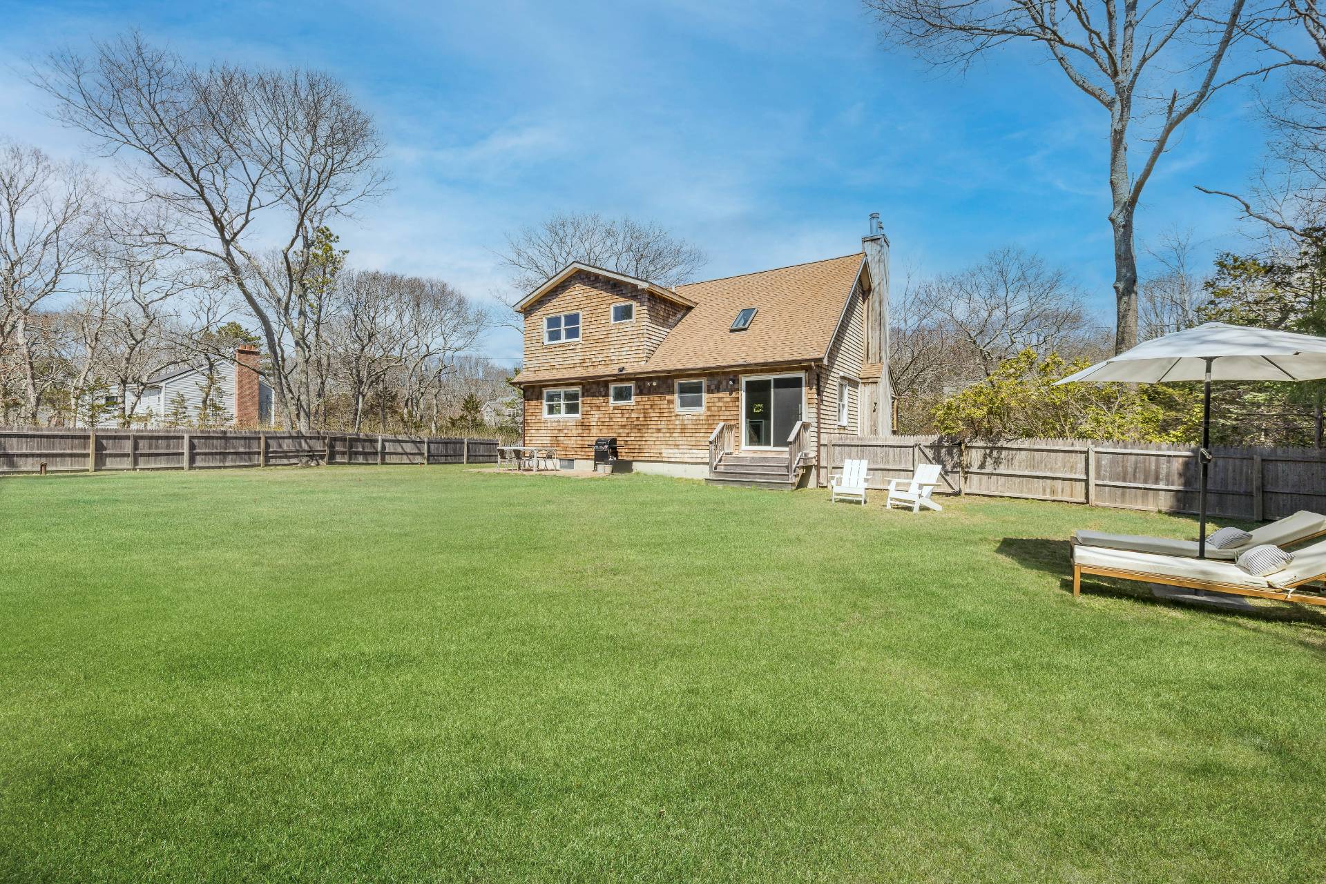 a front view of a house with a yard table and chairs