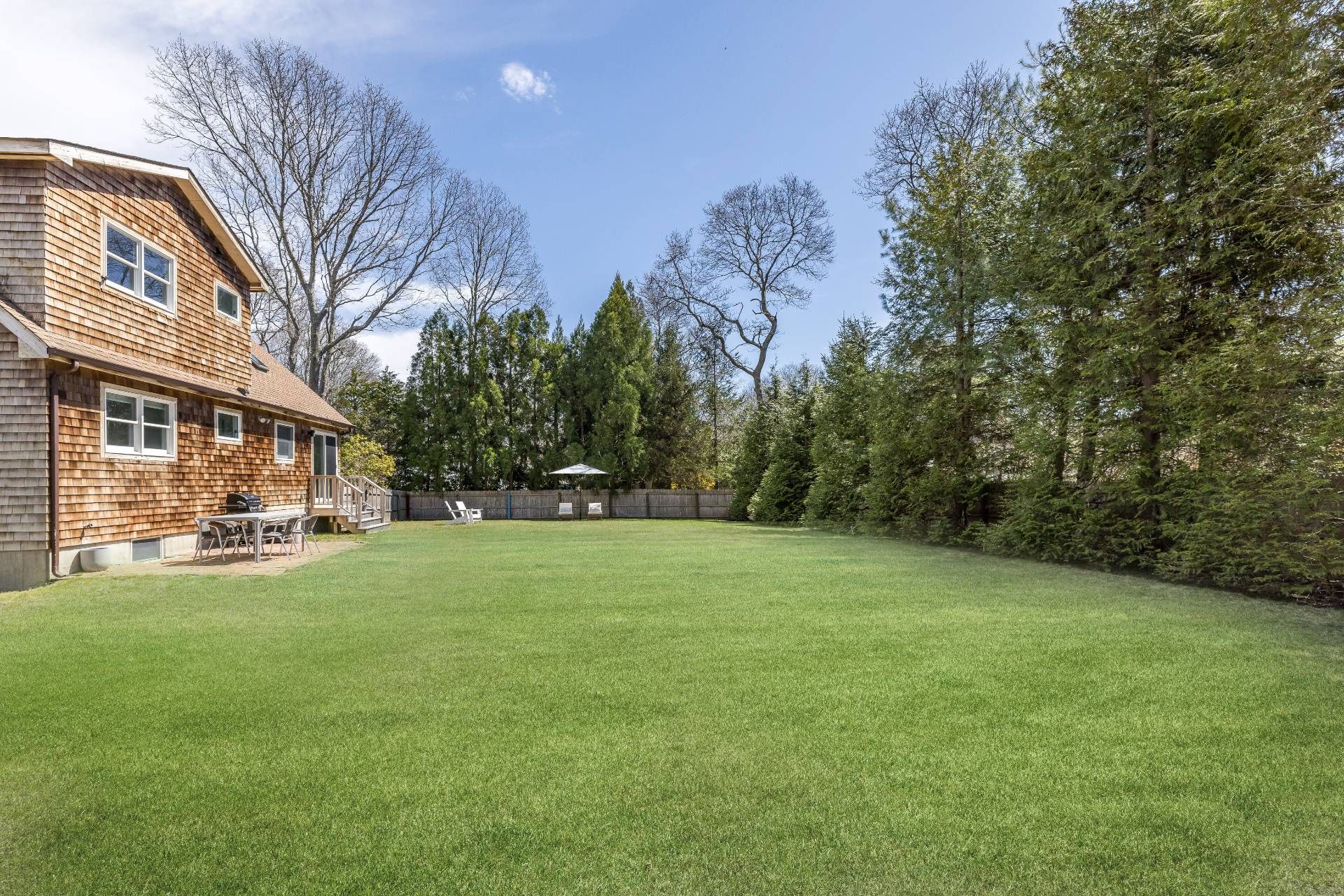 16 Central Avenue East Hampton, NY 11937 - Photo 16 of 16 a view of a yard with a house in the background