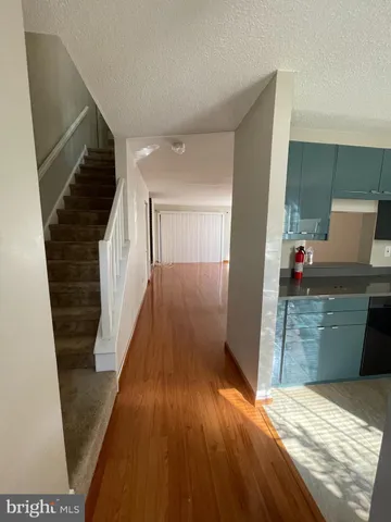 a view of a kitchen from the hallway