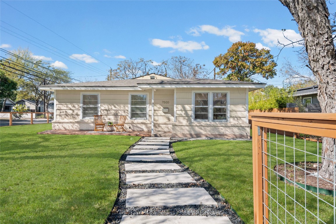 a front view of a house with a yard table and chairs