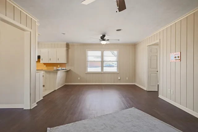 a kitchen with granite countertop white cabinets and sink