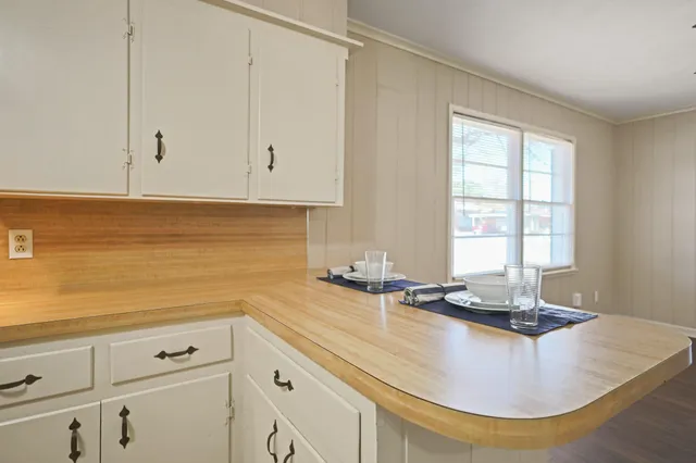a kitchen with sink a stove and cabinets
