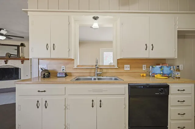 a view of a livingroom with wooden floor and a window
