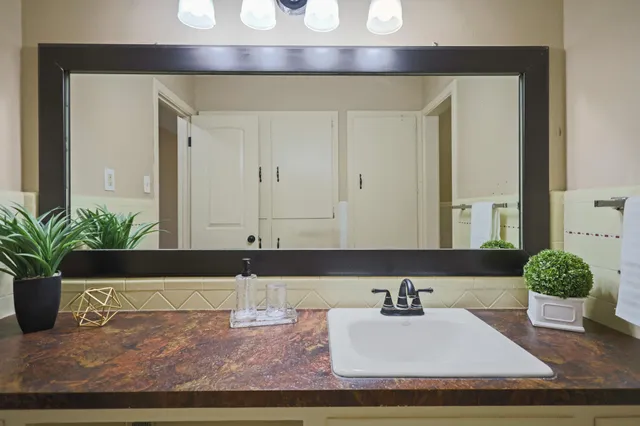 a front view of a house with a yard covered with snow