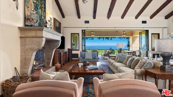 a living room with furniture and a floor to ceiling window