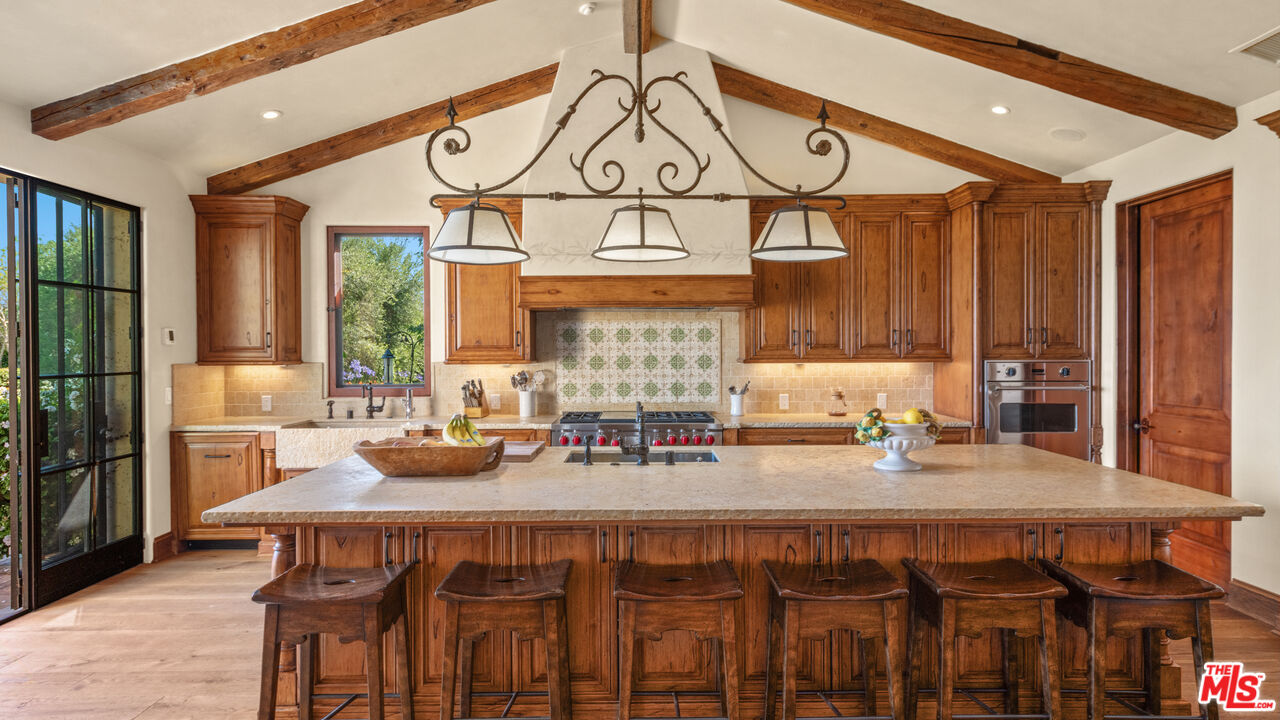 2900 Corral Canyon Road Malibu, CA 90265 - Photo 17 of 48 a kitchen with a table and chairs in it