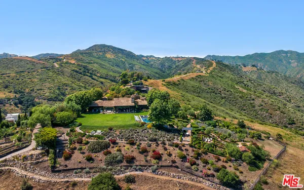 a view of a lush green hillside and houses