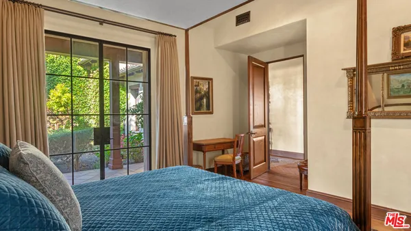 a bedroom with a bed and ceiling fan