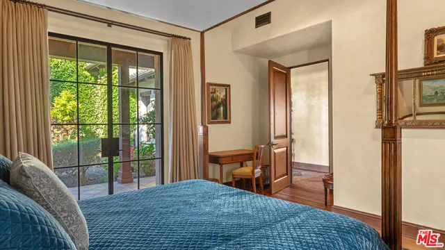 a bedroom with a bed and ceiling fan