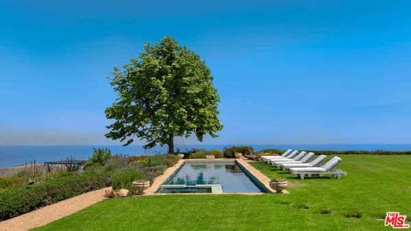 an aerial view of a house with a ocean view