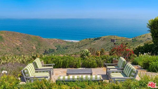 a view of a chairs and table in the patio