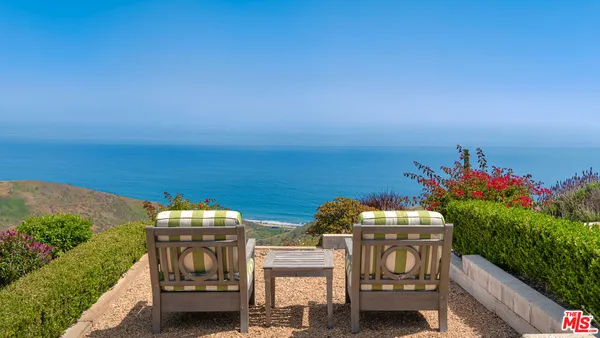 a view of a garden with an outdoor seating