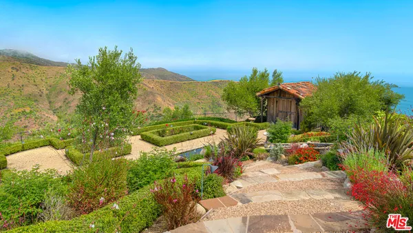 a view of a garden with a house