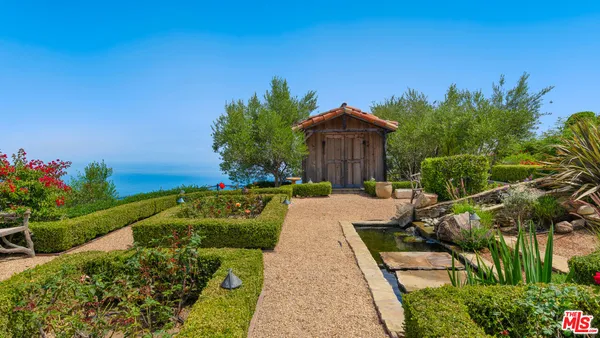 a view of a chairs and table in the garden